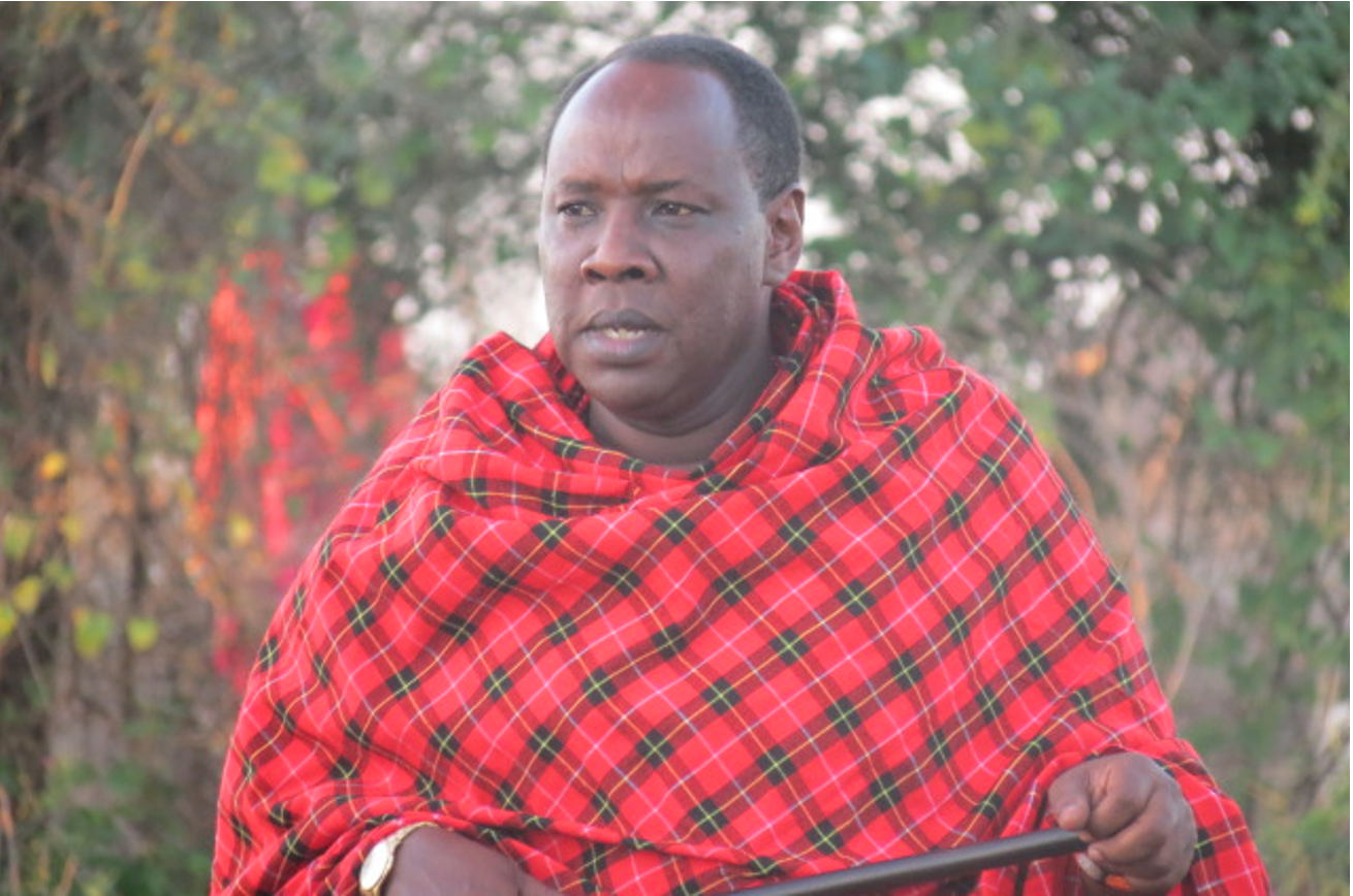 Martin Saning'o Kariongi Ole Sanago, OMASI's founder, with a patterned Maasai blanket over his shoulders.